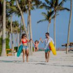 Happy family with little child enjoying time at holiday in exotic country.
