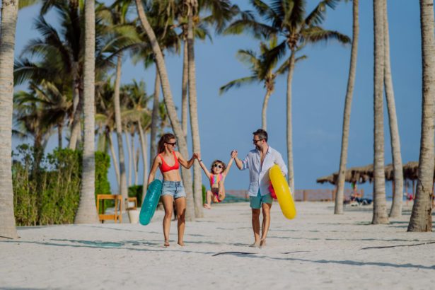 Happy family with little child enjoying time at holiday in exotic country.