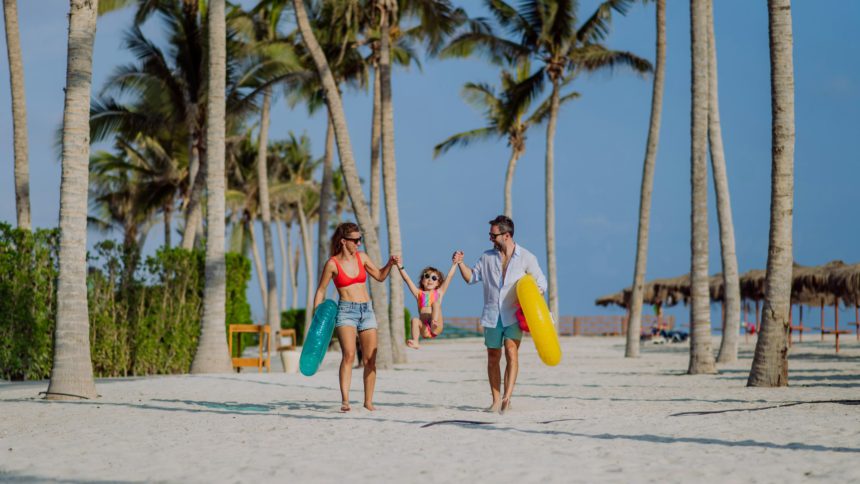 Happy family with little child enjoying time at holiday in exotic country.