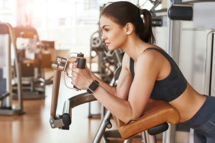 Perfect exercise program. Side view of sporty and beautiful young woman in sportswear and with smart